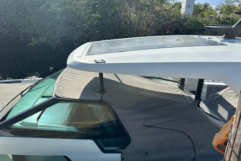 Slide: The Image of 2023 Saxdor 320 GTO boat with covered deck and sleek design. - 8