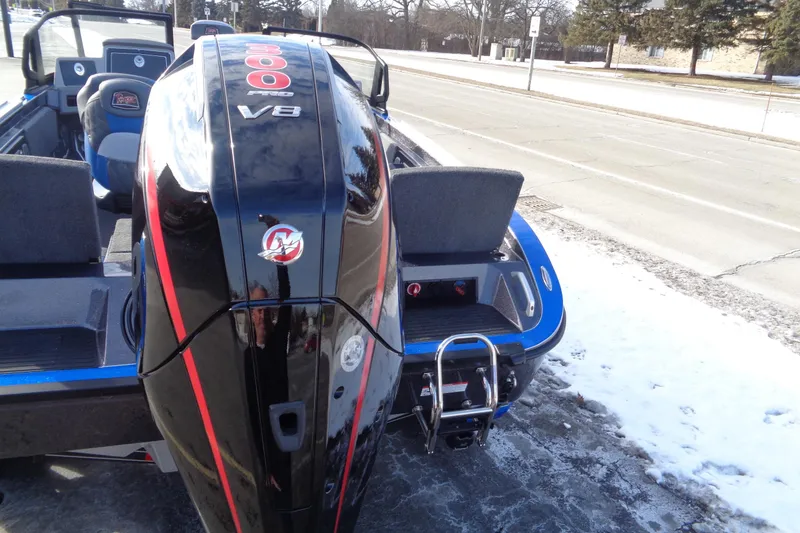 Slide: The Image of 2026 Ranger 620xFS Pro boat with powerful V8 engine, parked on snowy roadside. - 13