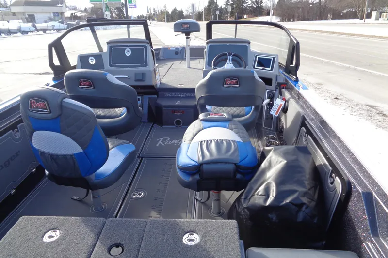 Slide: The Image of 2026 Ranger 620xFS Pro boat interior with blue and gray seating, dashboard, and steering wheel. - 14