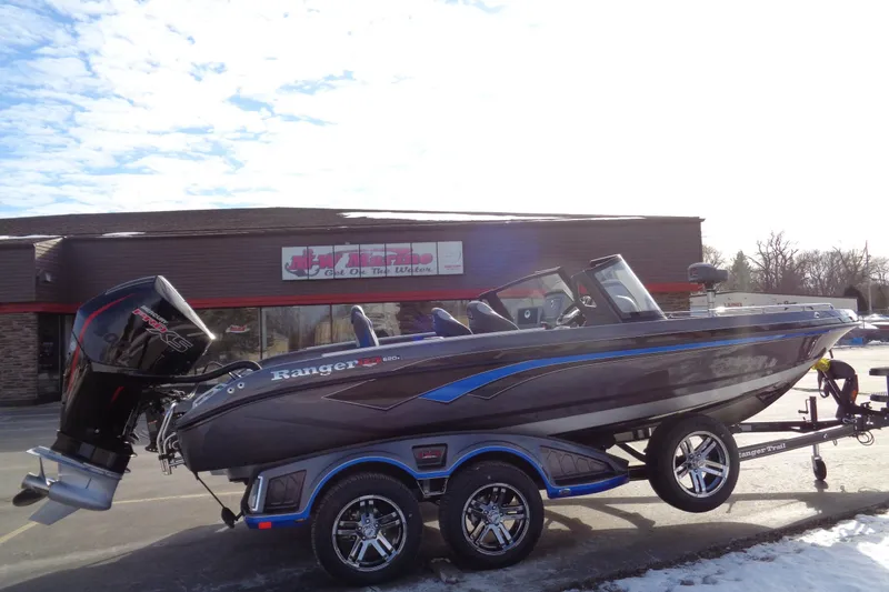 Slide: The Image of 2026 Ranger 620xFS Pro boat on trailer, parked outside a building. - 15