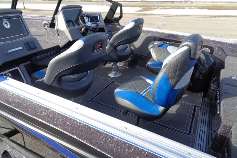 Slide: The Image of 2026 Ranger 620xFS Pro boat interior with blue and black seating, modern dashboard. - 16