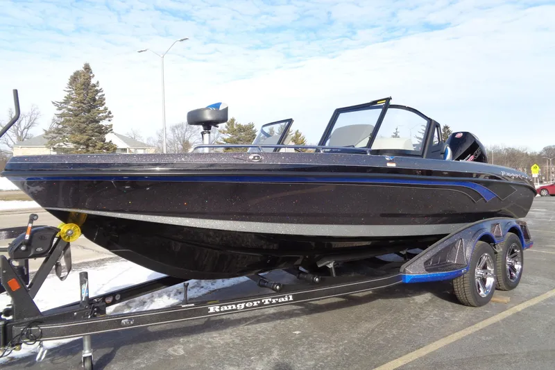 Slide: The Image of 2026 Ranger 620xFS Pro boat on trailer, parked outdoors. - 17