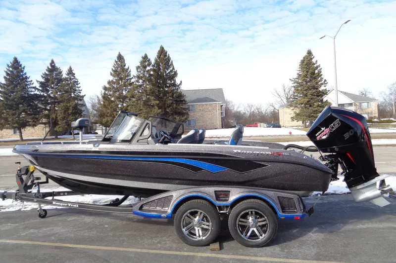 Slide: The Image of 2026 Ranger 620xFS Pro boat on trailer, parked outdoors, under a clear sky. - 2