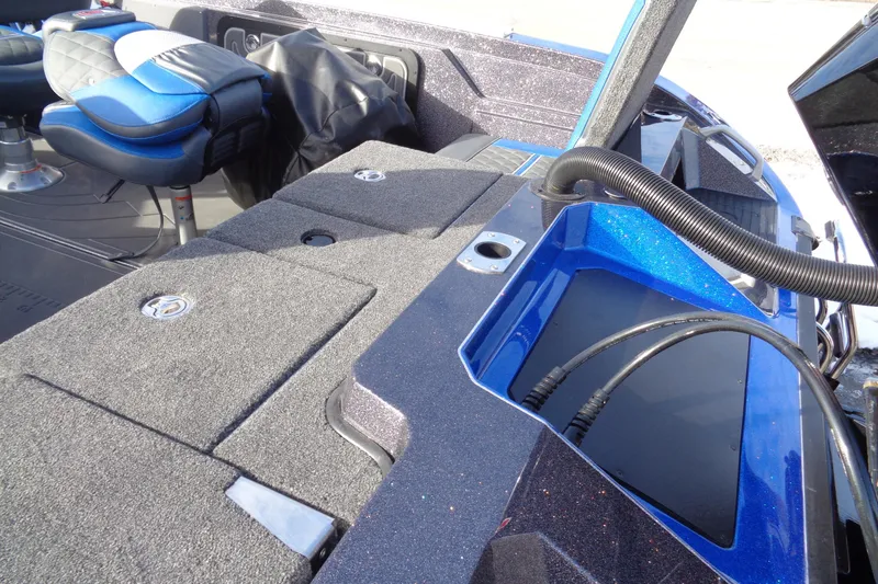 Slide: The Image of 2026 Ranger 620xFS Pro boat interior with blue seating and storage compartments. - 22