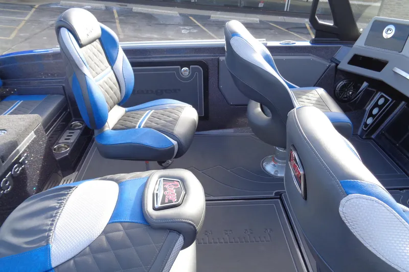 Slide: The Image of 2026 Ranger 620xFS Pro boat interior with blue and black seating. - 25
