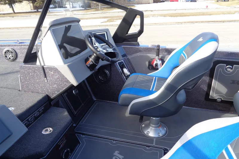 Slide: The Image of 2026 Ranger 620xFS Pro boat interior with modern dashboard and blue seating. - 5