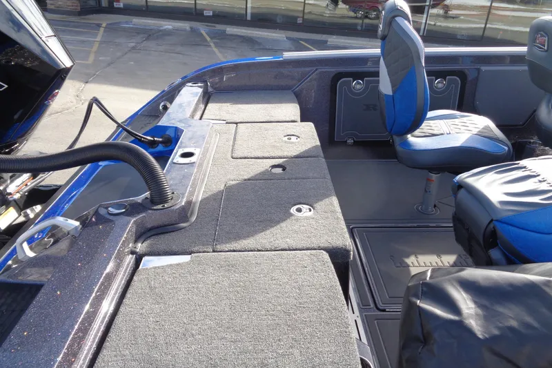 Slide: The Image of 2026 Ranger 620xFS Pro boat interior with blue seats and storage compartments. - 7