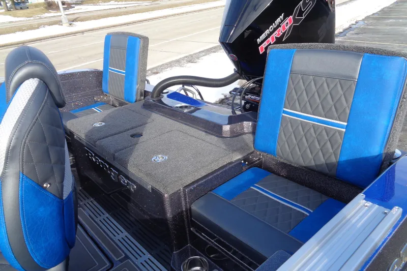 Slide: The Image of 2026 Ranger 620xFS Pro boat interior with blue and black seating, featuring Mercury Pro XS engine. - 8