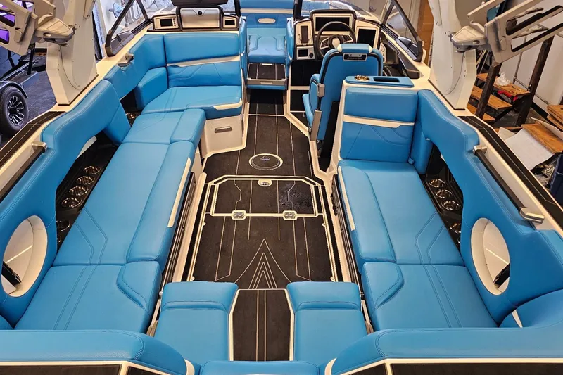 Slide: The Image of 2023 Supra SE 550 boat interior with blue seating and modern design. - 15