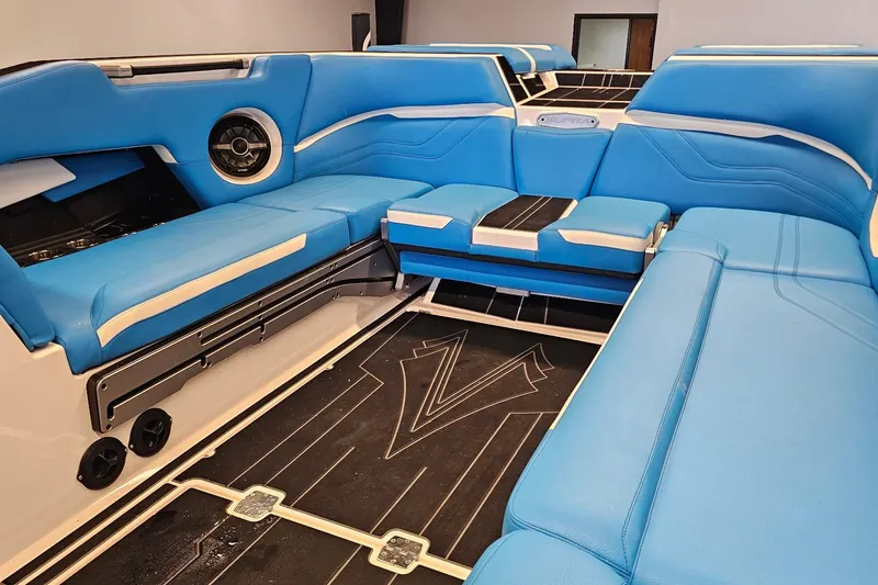 Slide: The Image of 2023 Supra SE 550 boat interior with blue seating and modern design. - 16