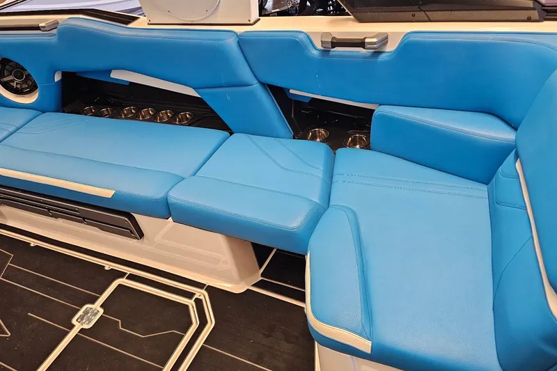 Slide: The Image of 2023 Supra SE 550 boat interior with blue seating and modern design. - 17
