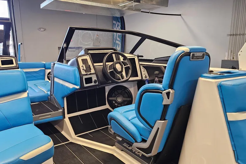 Slide: The Image of 2023 Supra SE 550 boat interior with blue seating and modern dashboard. - 19
