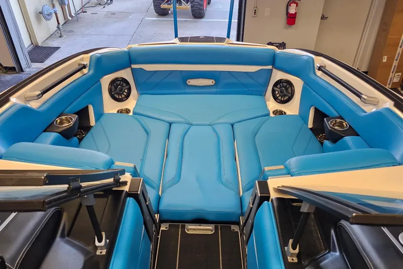 Slide: The Image of 2023 Supra SE 550 boat interior with blue seating and built-in speakers. - 20