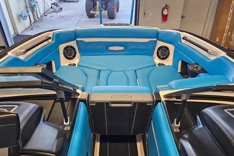 Slide: The Image of 2023 Supra SE 550 boat interior with blue seating and modern design. - 21