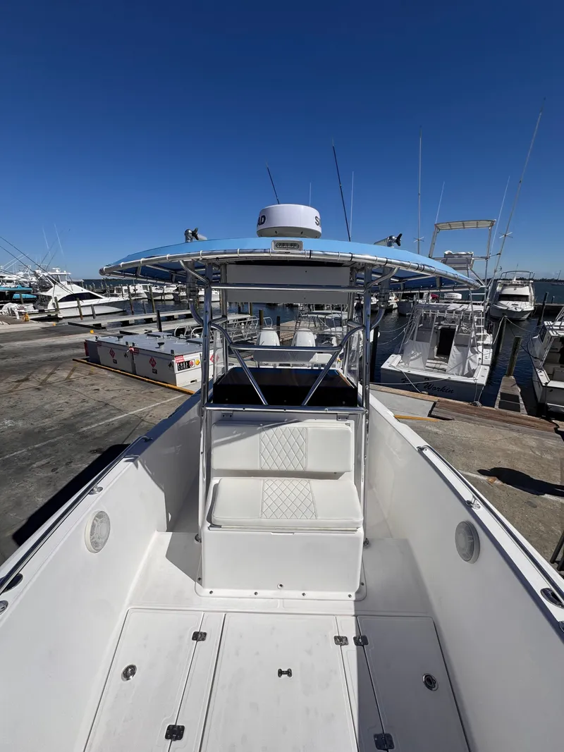 Slide: The Image of 2003 Bluewater 24 boat docked at marina, clear sky. - 4