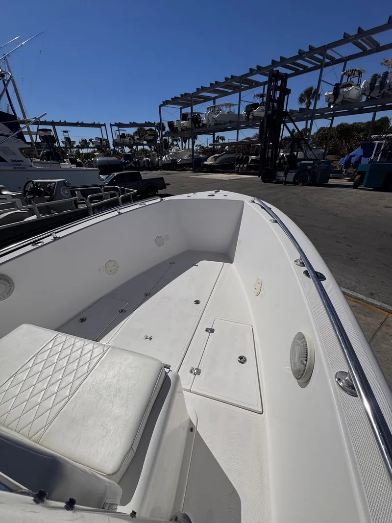 Slide: The Image of Interior view of a 2003 Bluewater 24 boat at the marina. - 5