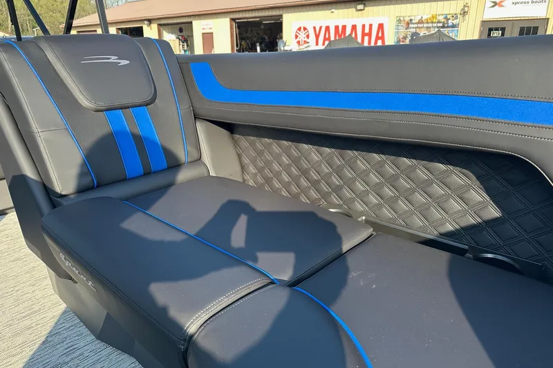 Slide: The Image of 2026 Bennington 22 SSR Quad Bench interior with blue accents, showcasing luxury seating design. - 11