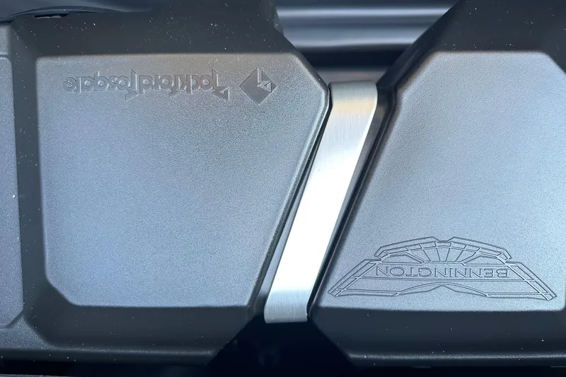 Slide: The Image of Close-up of Bennington 22 SSR Quad Bench logo on sleek black surface. - 16