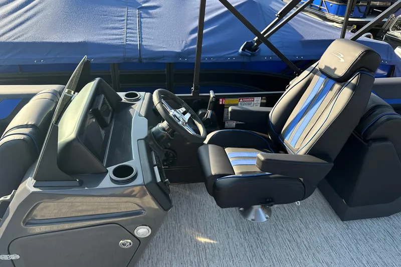 Slide: The Image of 2026 Bennington 22 SSR Quad Bench boat interior with sleek captain's chair and control panel. - 18