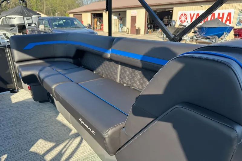 Slide: The Image of 2026 Bennington 22 SSR Quad Bench with sleek black and blue seating, outdoor setting. - 21