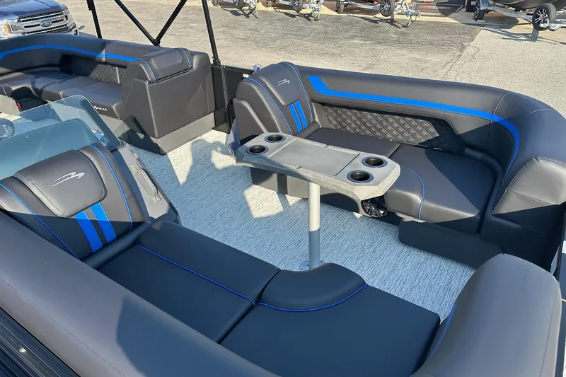 Slide: The Image of Interior of 2026 Bennington 22 SSR Quad Bench pontoon boat with sleek seating and table. - 9