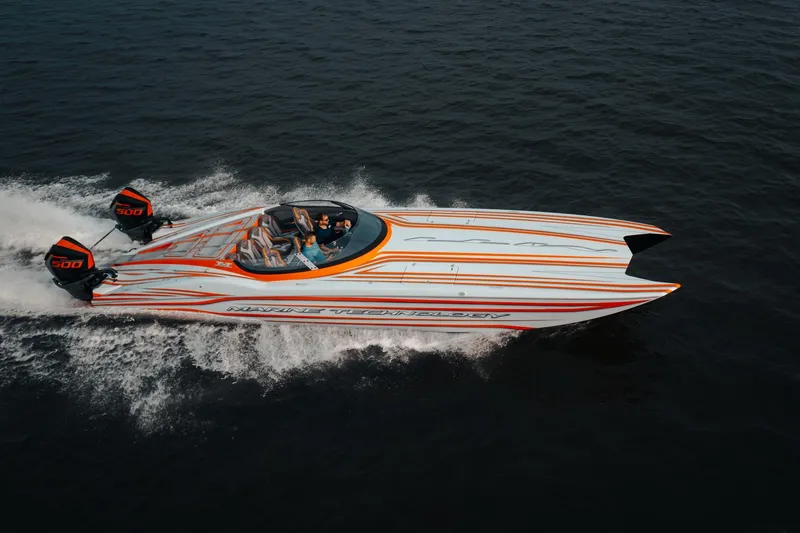 Slide: The Image of 2024 MTI 390X speedboat with dual engines cruising on open water. - 11
