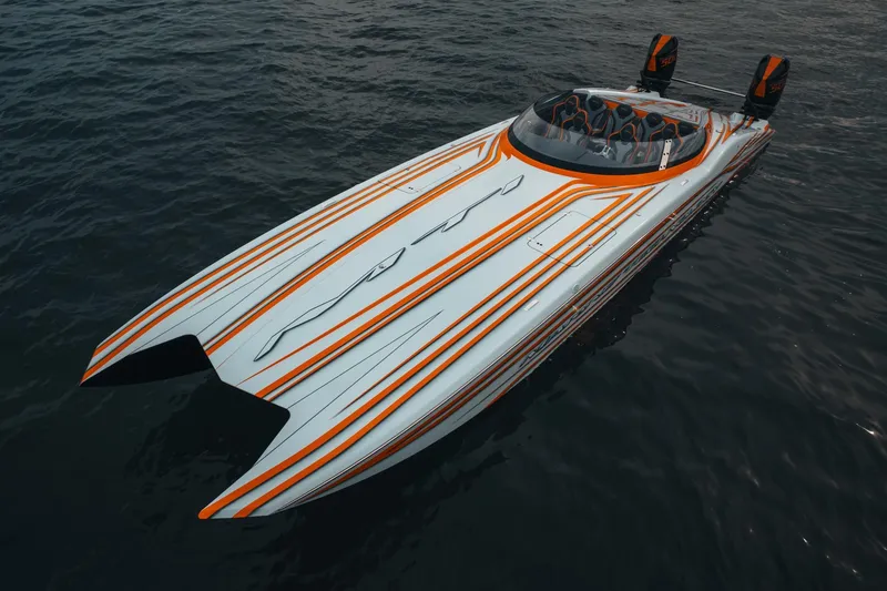 Slide: The Image of 2024 MTI 390X powerboat with sleek orange and white design on water. - 3