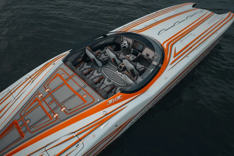 Slide: The Image of 2024 MTI 390X speedboat with sleek orange and gray design on water. - 5