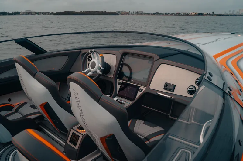 Slide: The Image of 2024 MTI 390X boat interior with modern dashboard and sleek design on the water. - 8