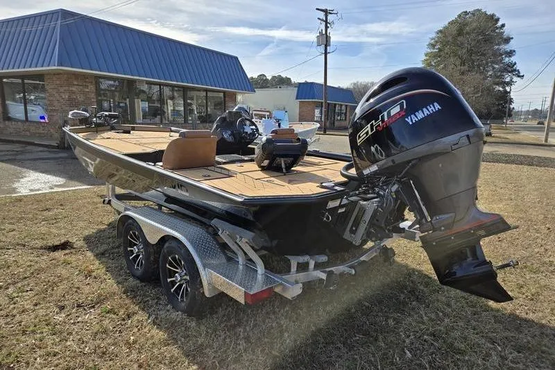 Slide: The Image of 2026 Avid 20 Vertex boat with Yamaha engine on trailer, parked outside a building. - 9