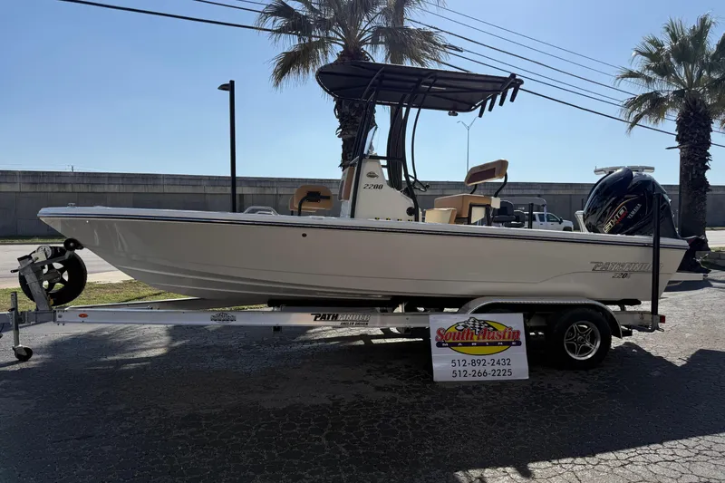The Image of 2026 Pathfinder 2200 TRS boat on trailer, displayed outdoors with palm trees. - 0