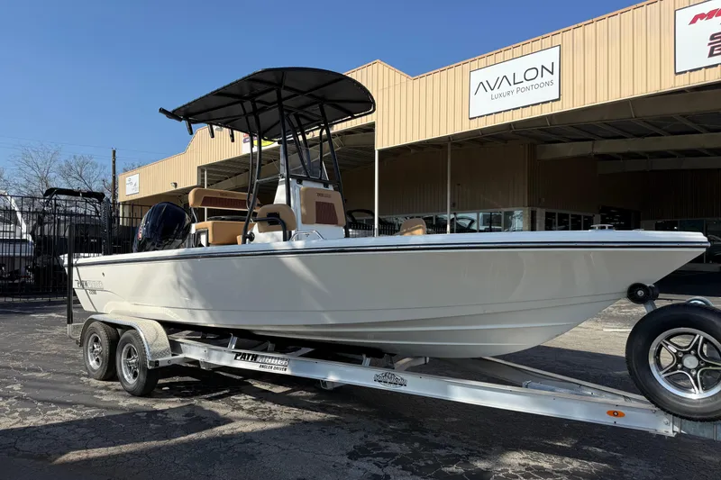 Slide: The Image of 2026 Pathfinder 2200 TRS boat on trailer outside Avalon Luxury Pontoons dealership. - 2