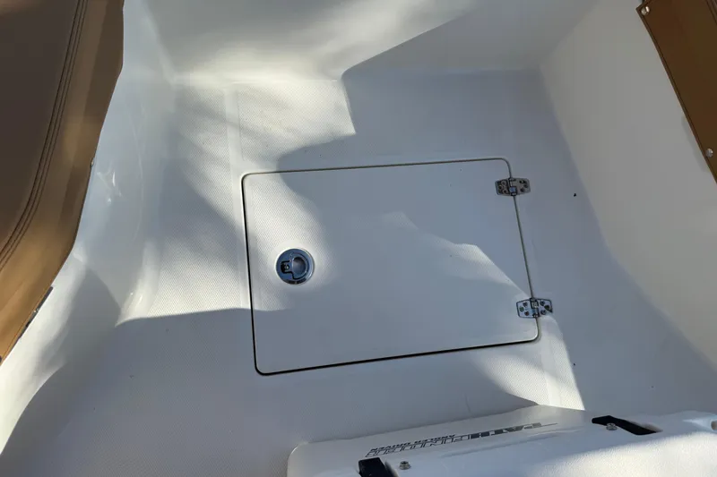 Slide: The Image of 2026 Pathfinder 2200 TRS boat deck with storage compartment and latch. - 33