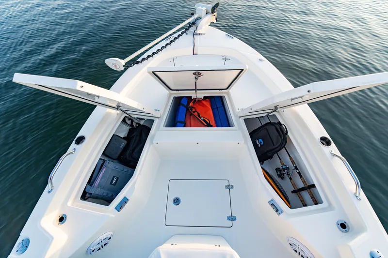 Slide: The Image of Manufacturer Provided Image: 2026 Pathfinder 2200 TRS boat with open storage compartments on calm water. - 46