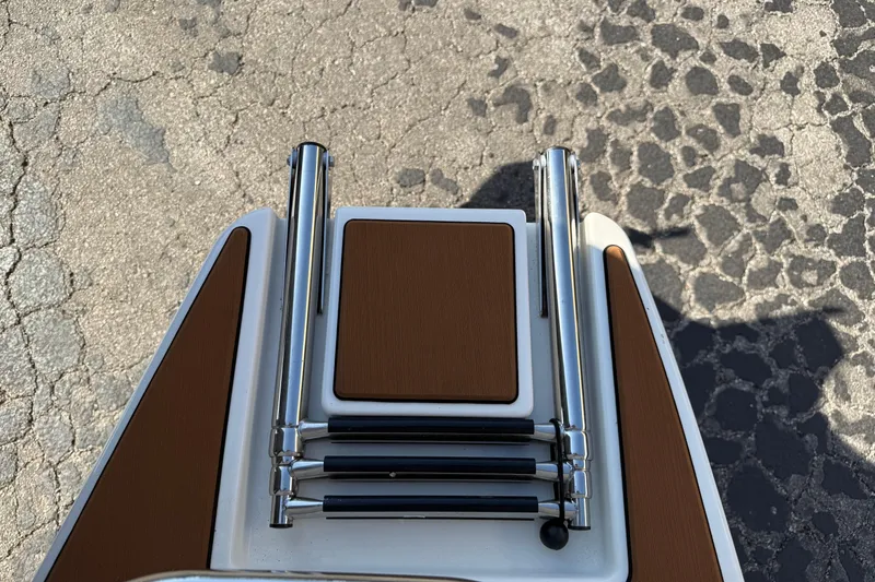 Slide: The Image of 2026 Pathfinder 2200 TRS boat ladder on textured pavement background. - 7