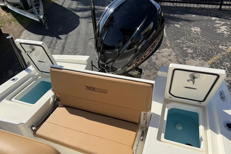 Slide: The Image of 2026 Pathfinder 2200 TRS boat with tan seating and open storage compartments. - 9