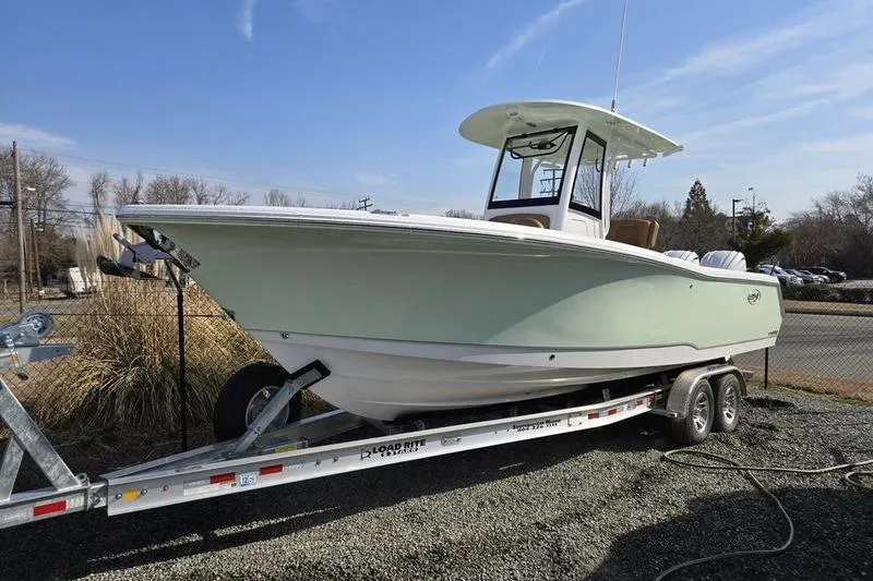 The Image of 2026 Sea Hunt Gamefish 27 Forward Seating boat on trailer, outdoor setting. - 1