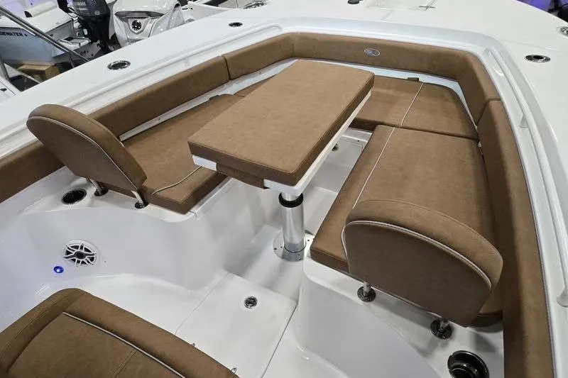 Slide: The Image of 2026 Sea Hunt Gamefish 27 Forward Seating with brown cushioned seats and table. - 13
