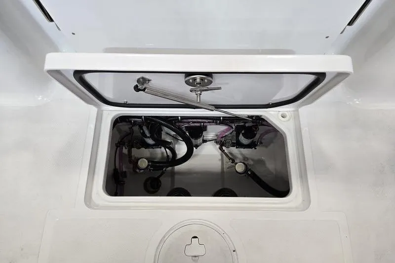 Slide: The Image of Open hatch of 2026 Sea Hunt Gamefish 27 Forward Seating boat, showing internal components. - 15