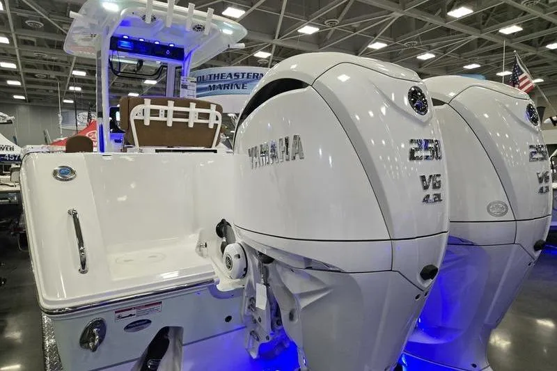 Slide: The Image of 2026 Sea Hunt Gamefish 27 with Yamaha engines displayed at a boat show. - 3