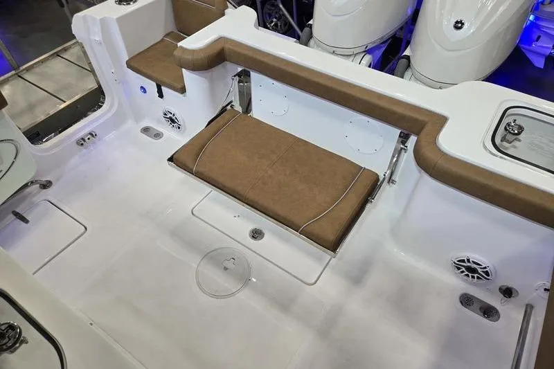 Slide: The Image of 2026 Sea Hunt Gamefish 27 boat interior with brown seating and white deck. - 9