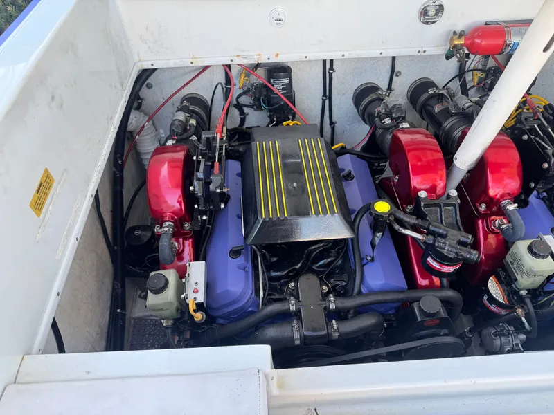 Slide: The Image of Engine compartment of a 1997 Baja 32 Outlaw boat with red engine covers. - 3