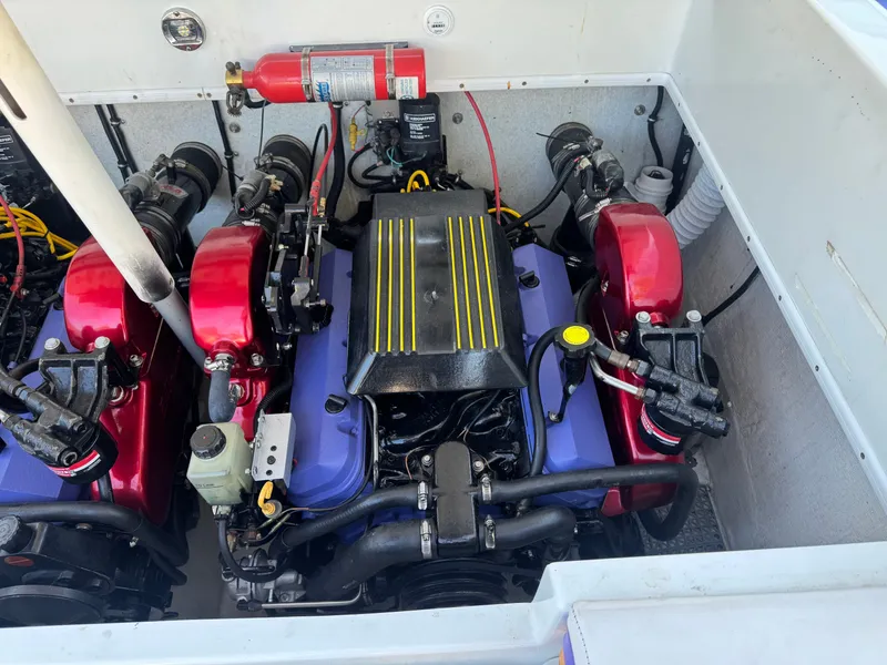 Slide: The Image of Engine compartment of a 1997 Baja 32 Outlaw boat with red and blue engine. - 4