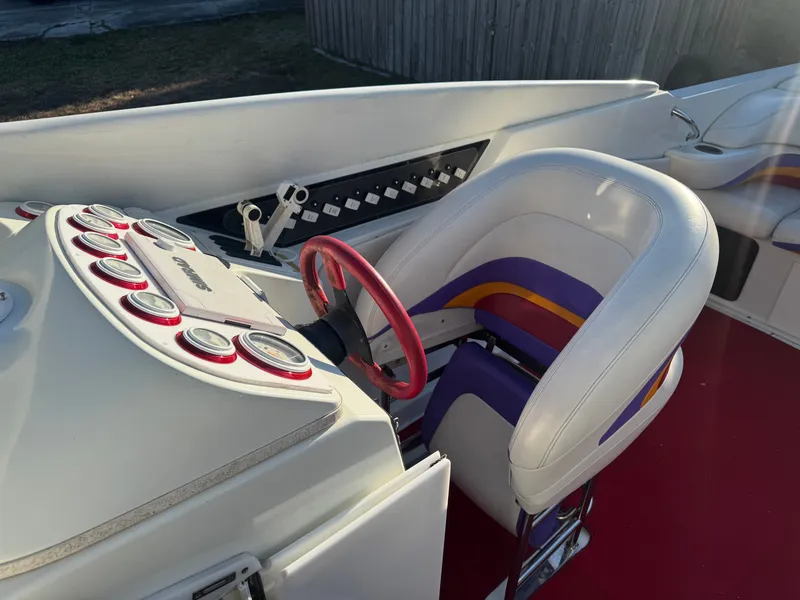 Slide: The Image of Interior of a 1997 Baja 32 Outlaw boat with red steering wheel. - 5