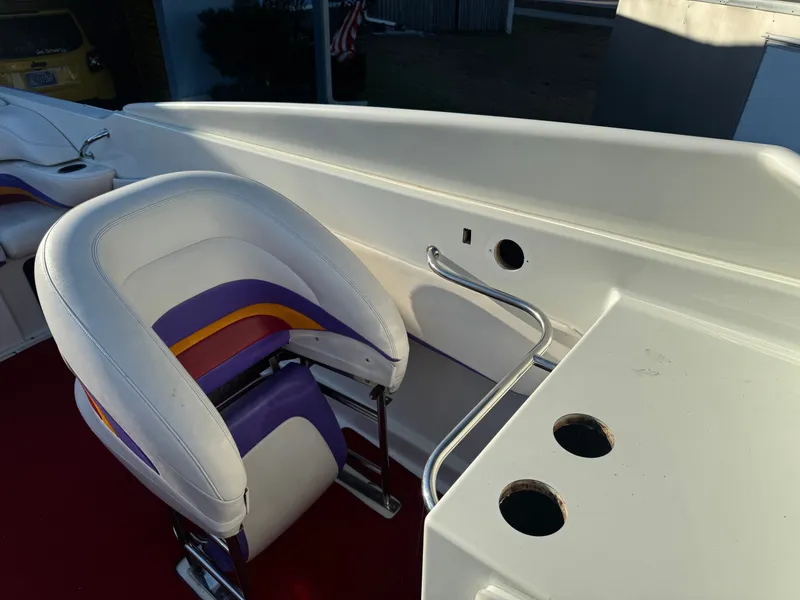Slide: The Image of Interior of a 1997 Baja 32 Outlaw boat with colorful seat. - 6