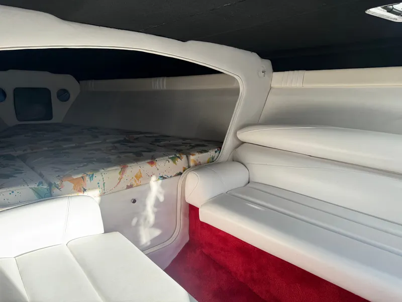Slide: The Image of Interior of a 1997 Baja 32 Outlaw boat with white seating. - 7