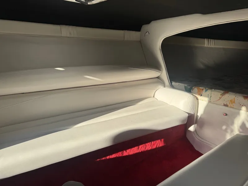 Slide: The Image of Interior of a 1997 Baja 32 Outlaw boat with white upholstery. - 9