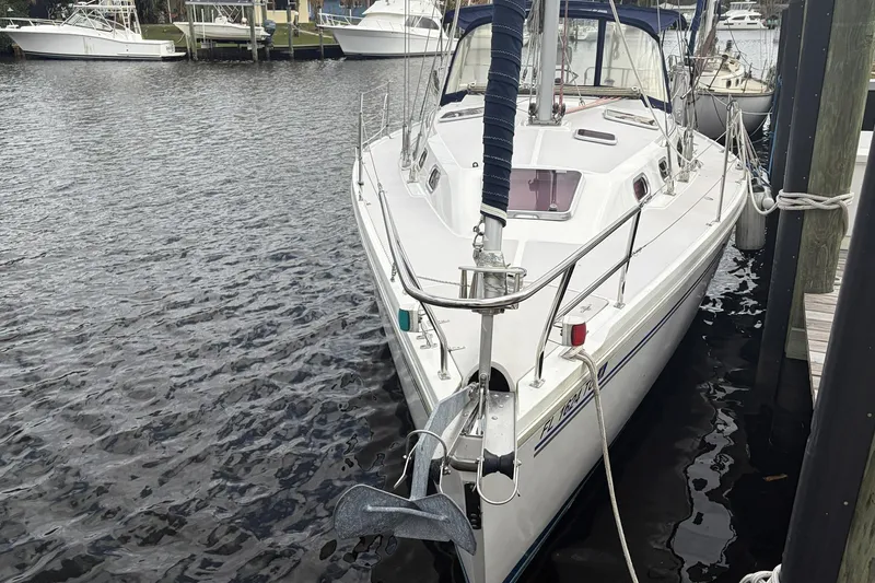 Slide: The Image of 2004 Catalina 36 MkII sailboat docked in a marina, front view. - 14