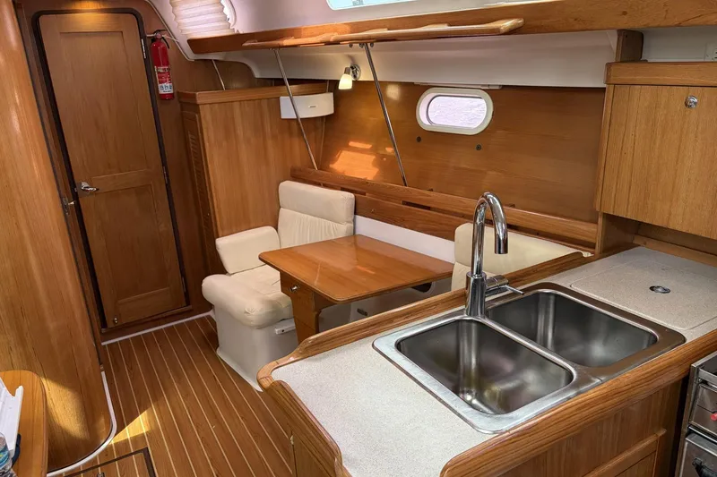 Slide: The Image of Interior of 2004 Catalina 36 MkII sailboat with wood finish and compact kitchen. - 19