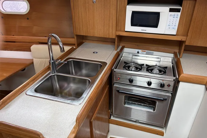 Slide: The Image of Galley kitchen in 2004 Catalina 36 MkII yacht with stove, sink, and microwave. - 21